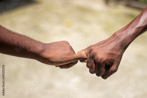 Two human hands holding two fingers together and blurred background © Rokonuzzamnan