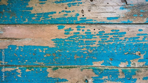 Old wood texture background. Floor surface with peeling blue paint.