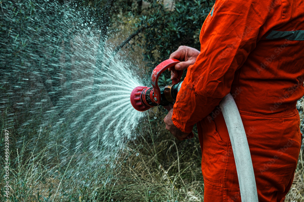 stcw fire fighting prevention training, man holding fire hose with water, maritime courses stcw fire fighting prevention training, man holding fire hose with water, maritime courses