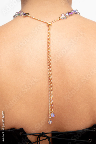 A chain with precious stones on a girl’s neck on a white background