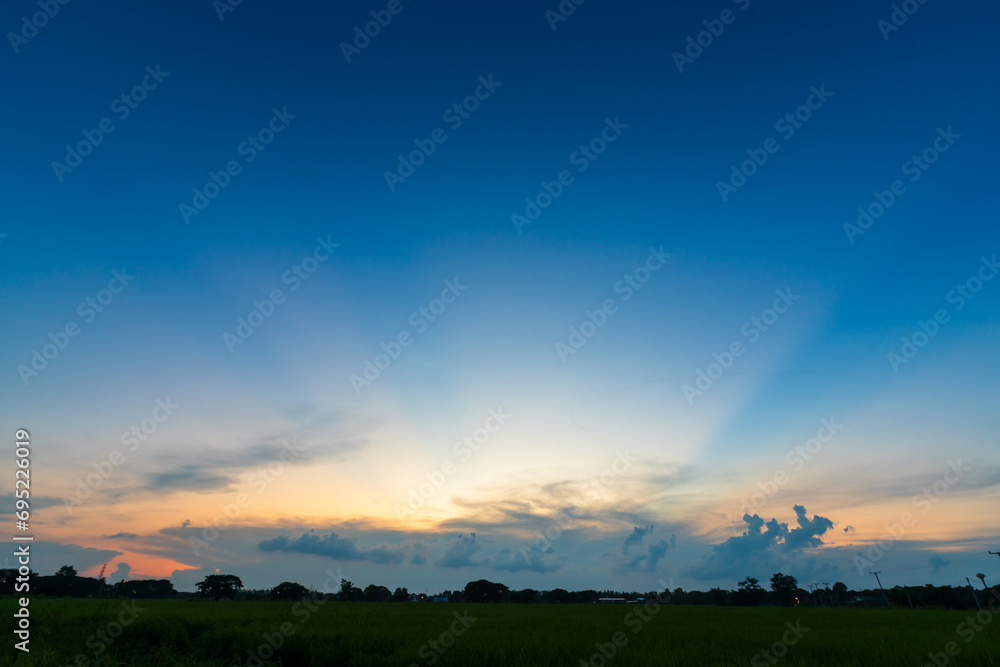 Twilight blue bright and orange yellow dramatic sunset sky in countryside or beach colorful cloudscape texture with white clouds air background. Twilight blue bright and orange yellow dramatic sunset sky in countryside or beach colorful cloudscape texture with white clouds air background.