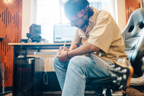 Musician writing a letter in a music home studio photo