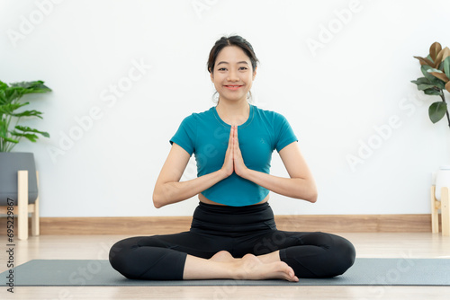 woman practicing meditate in condominium. Asian woman do exercises in morning. balance, recreation, relaxation, calm, good health, happy, relax, healthy lifestyle, reduce stress, peaceful, Attitude.
