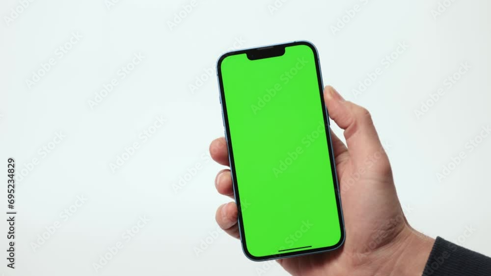 Close Up of Mobile Phone With Green Mock-up Screen In Men's Hands On ...