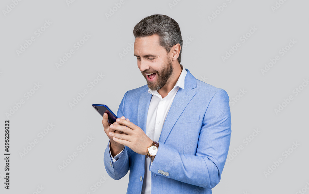 Man phone conversation in studio. happy hispanic business man with phone. Business communication. Casual business man chatting on phone isolated on grey. Businessman using phone Man phone conversation in studio. happy hispanic business man with phone. Business communication. Casual business man chatting on phone isolated on grey. Businessman using phone