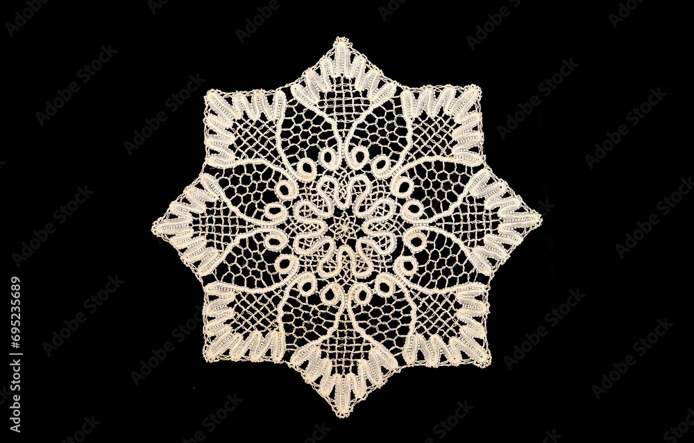 Vintage  white knitted napkin isolated on a black background.