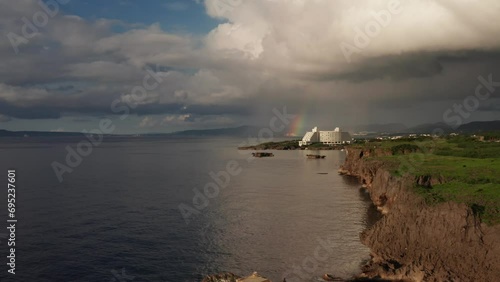 Aerial footage of Cape Manza Okinawa with a rainbow and resort hotel. photo