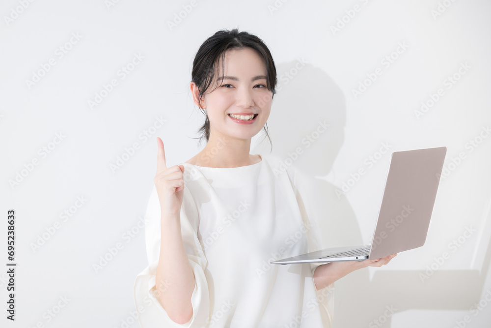Business image of a pretty young woman holding a computer and pointing. Business image of a pretty young woman holding a computer and pointing.