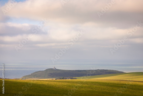 Calm peaceful midday view of Belle Tout lighthouse from Beachy Head on the south downs coast east Sussex south east England UK