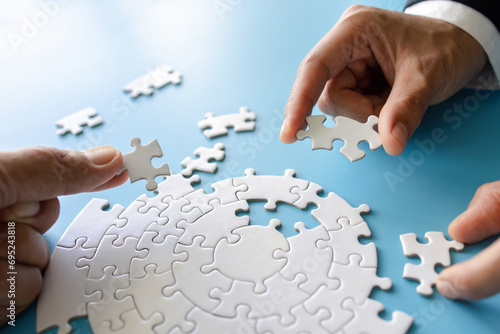  Hand put the last piece of jigsaw puzzle to complete the mission, Business solutions, success and strategy concept, The solution includes completing the mission.