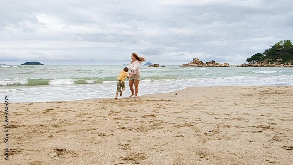 Mother and son spinning on sea. Family relax on coastline. Mother and son spinning on sea. Family relax on coastline.