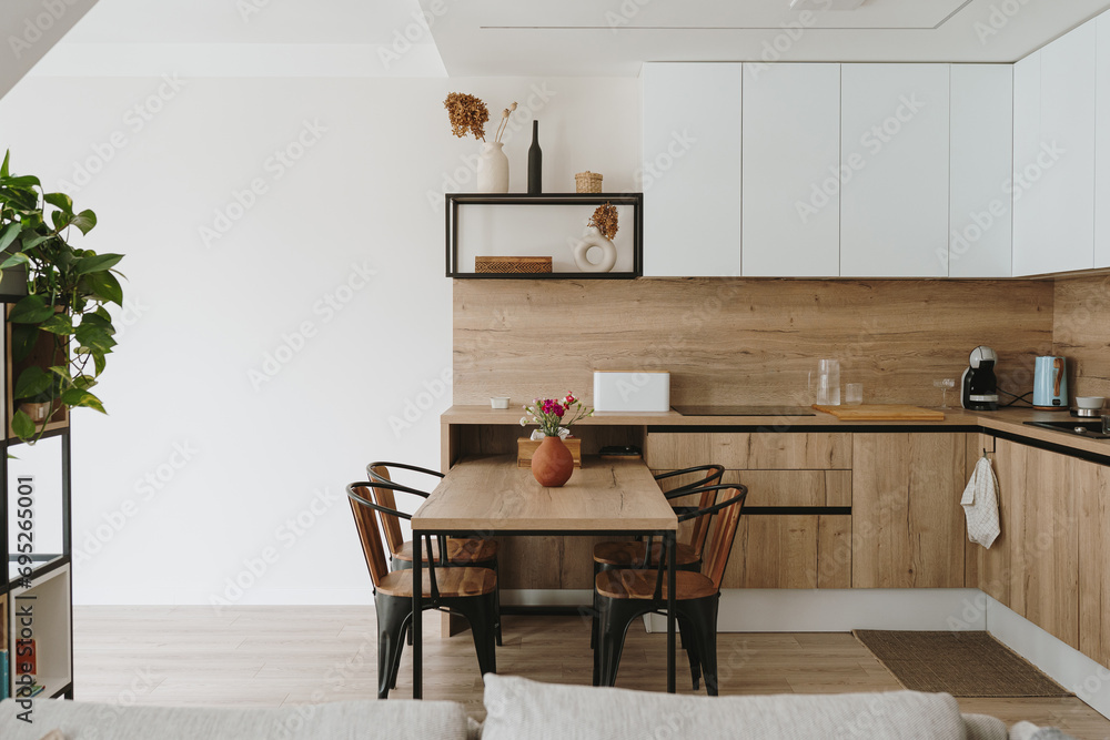 Obraz na płótnie Modern bright kitchen interior with white furniture and wooden dining table w salonie