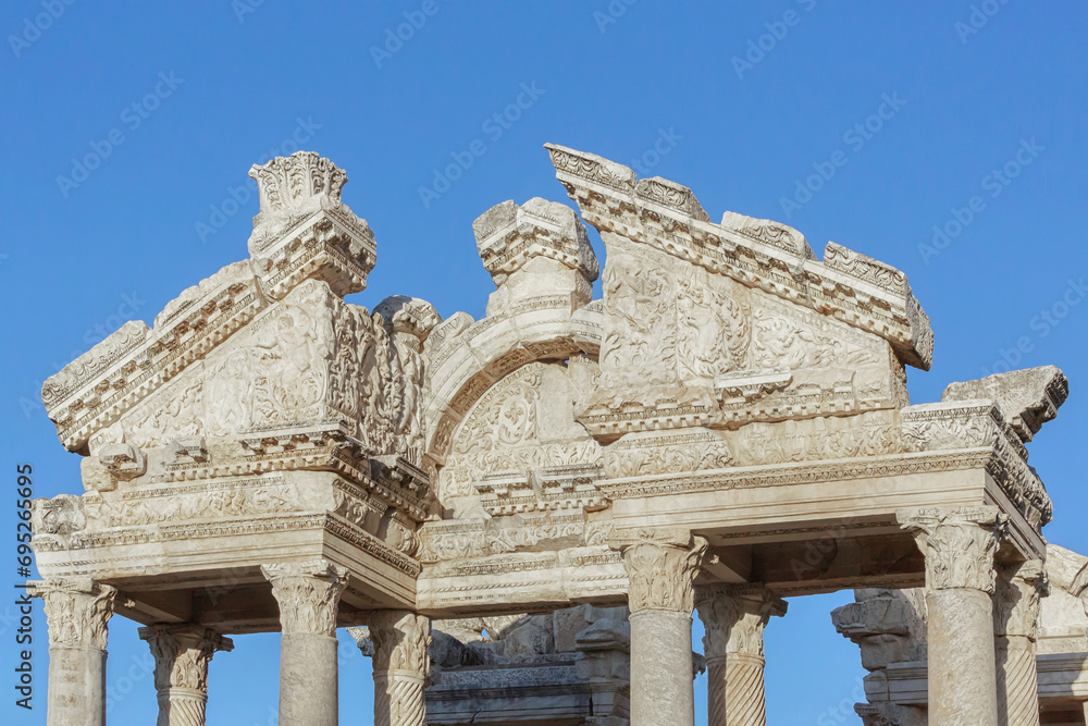 Fronton of Tetrapylon. The monumental gateway to the Temple of Aphrodite in ancient Aphrodisias. Close up, blue sky at background. Geyre (Aydin province), Turkey (Turkiye)