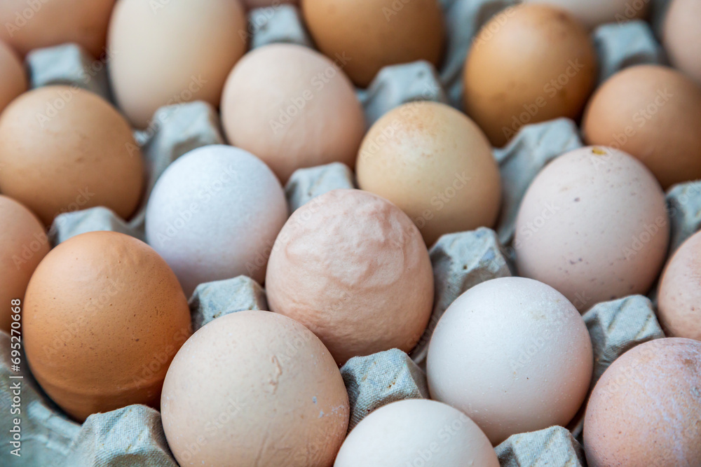 A close up of eggs in a tray with a shallow depth of field A close up of eggs in a tray with a shallow depth of field