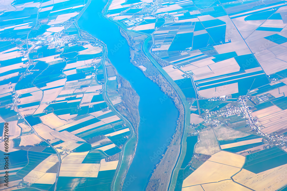 Aerial view of Danube river and agricultural fields with meadows