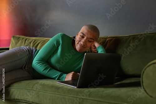 Female student using a laptop for study at home photo