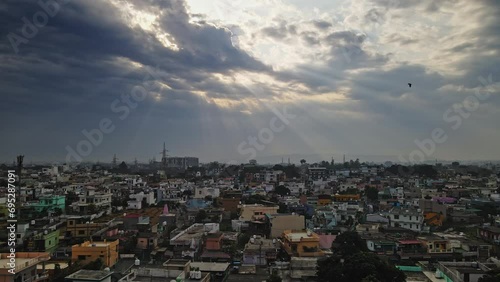 An aerial view of Dehradun, an Indian city during sunrise or sunset, with cloudy weather and rows of residential houses. photo