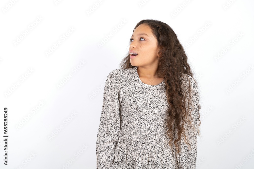 Beautiful teen girl wearing grey dress over white background very happy and excited about new plans. Beautiful teen girl wearing grey dress over white background very happy and excited about new plans.