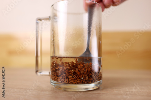 To prepare a therapeutic decoction, flax seeds are shaken in a glass of boiling water.
