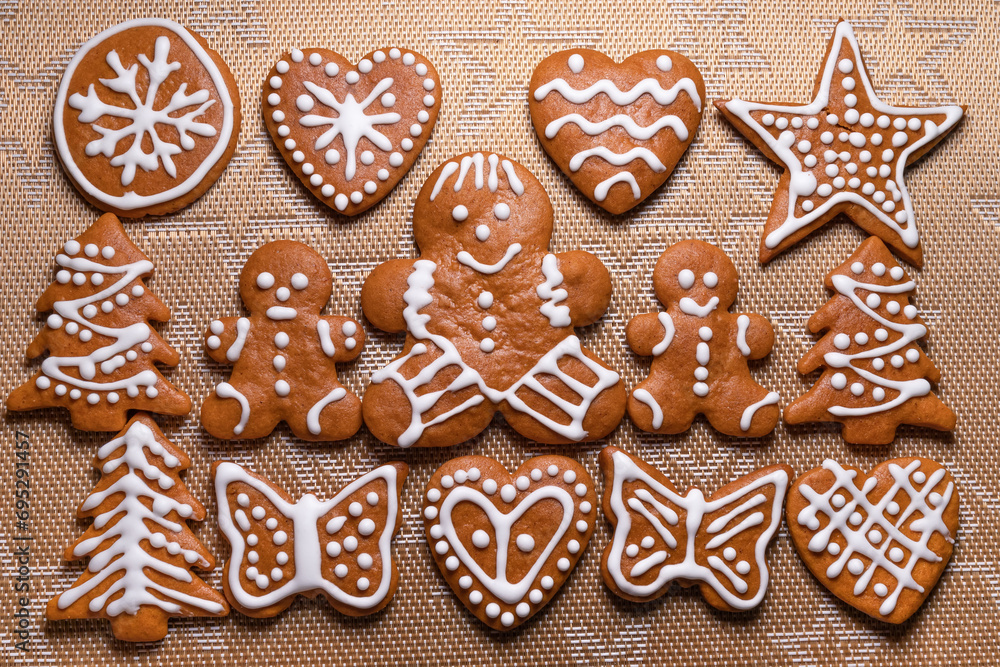Christmas gingerbread cookies of various shapes covered with white sugar icing. Top view of ready-to-eat homemade gingerbread cookies on table Christmas gingerbread cookies of various shapes covered with white sugar icing. Top view of ready-to-eat homemade gingerbread cookies on table