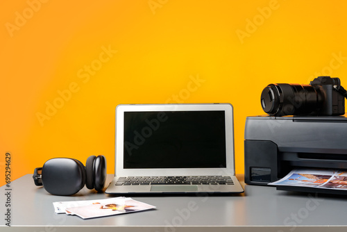 Printer, laptop and camera on table close up. Printing photos