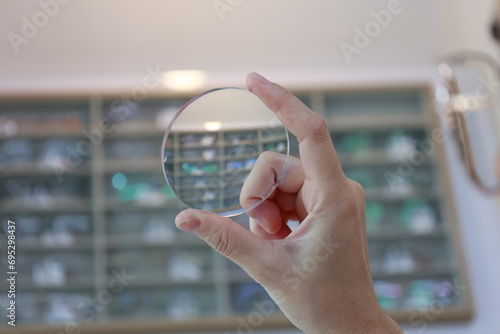 person holding glasses lenses 