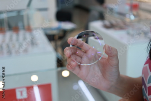 Fototapeta Naklejka Na Ścianę i Meble -  Eyeglasses lenses in hand 