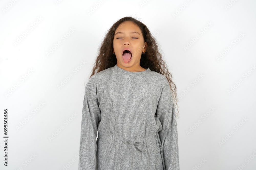 Beautiful teenager girl sticking tongue out happy with funny expression. Emotion concept. Beautiful teenager girl sticking tongue out happy with funny expression. Emotion concept.