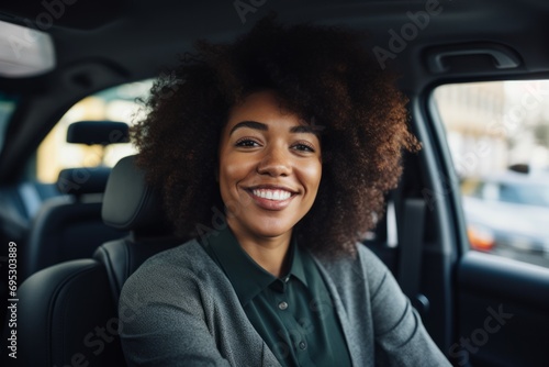 Elegant woman driver looking at backseat, smiling happy, Businesswoman talking to person in her car, driving at work.