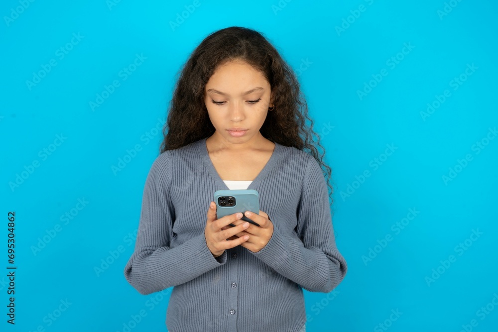 Focused Beautiful teenager girl use smartphone reading social media news, or important e-mail Focused Beautiful teenager girl use smartphone reading social media news, or important e-mail