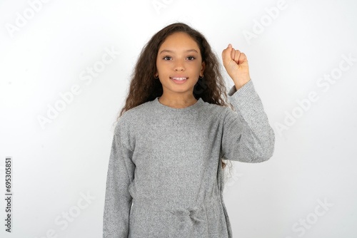 Beautiful teenager girl  pointing up with fingers number ten in Chinese sign language Shi photo