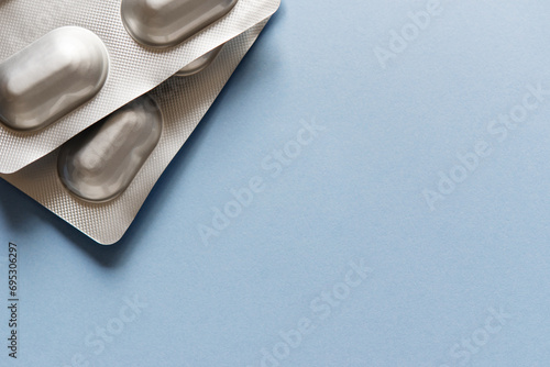Medicine blister strip on a plain blue background. Pharmacy products. Medicine pills. photo