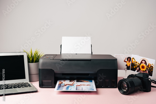 Printer, laptop and camera on table close up. Printing photos