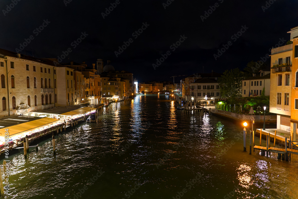 City of Venice on a dark summer night with scenic view seen form Scalzi Bridge over Grand Canal with cityscape and city lights. Photo taken August 6th, 2023, Venice, Italy.
