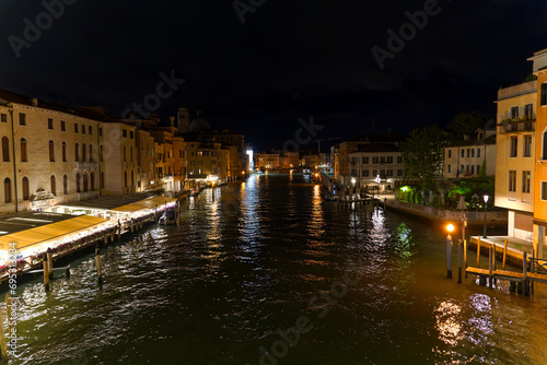 City of Venice on a dark summer night with scenic view seen form Scalzi Bridge over Grand Canal with cityscape and city lights. Photo taken August 6th, 2023, Venice, Italy.