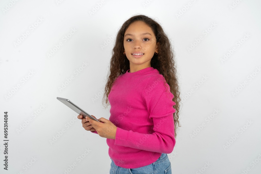 Photo of optimistic Young beautiful teen girl hold tablet Photo of optimistic Young beautiful teen girl hold tablet