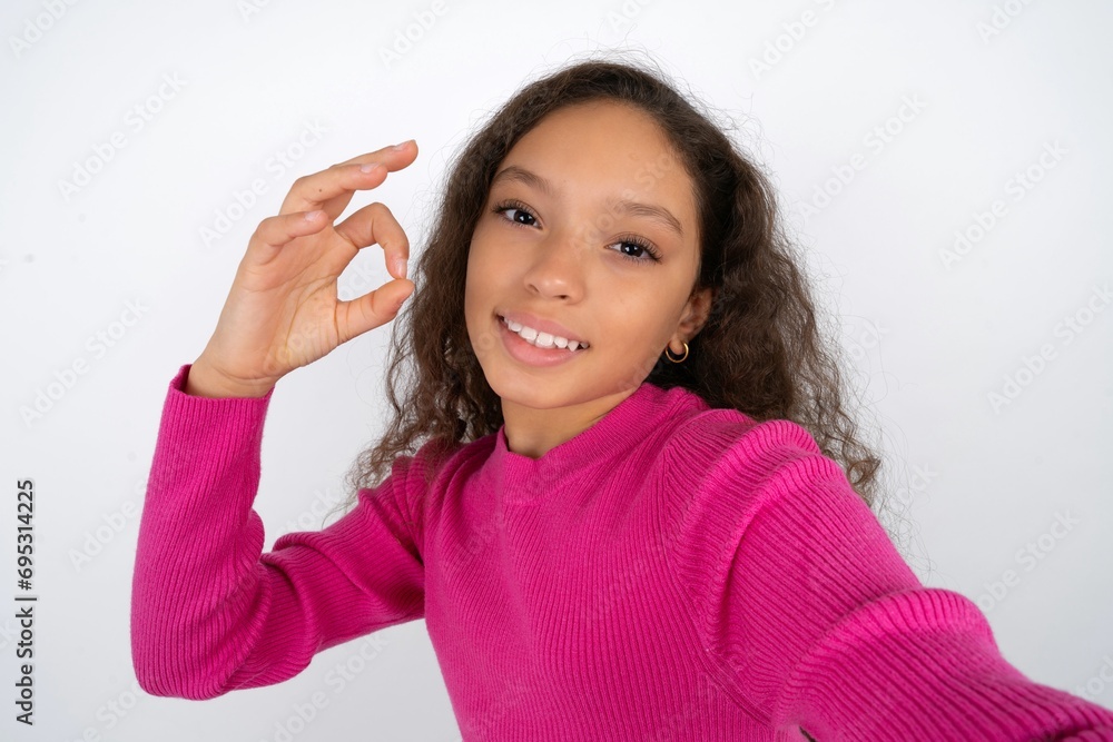 Portrait of pretty cheerful Young beautiful teen girl make selfie show okey symbol Portrait of pretty cheerful Young beautiful teen girl make selfie show okey symbol