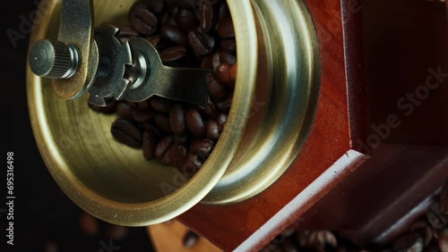 Vintage wood coffee grinder with coffee beans. Coffee machine. Vertical video photo
