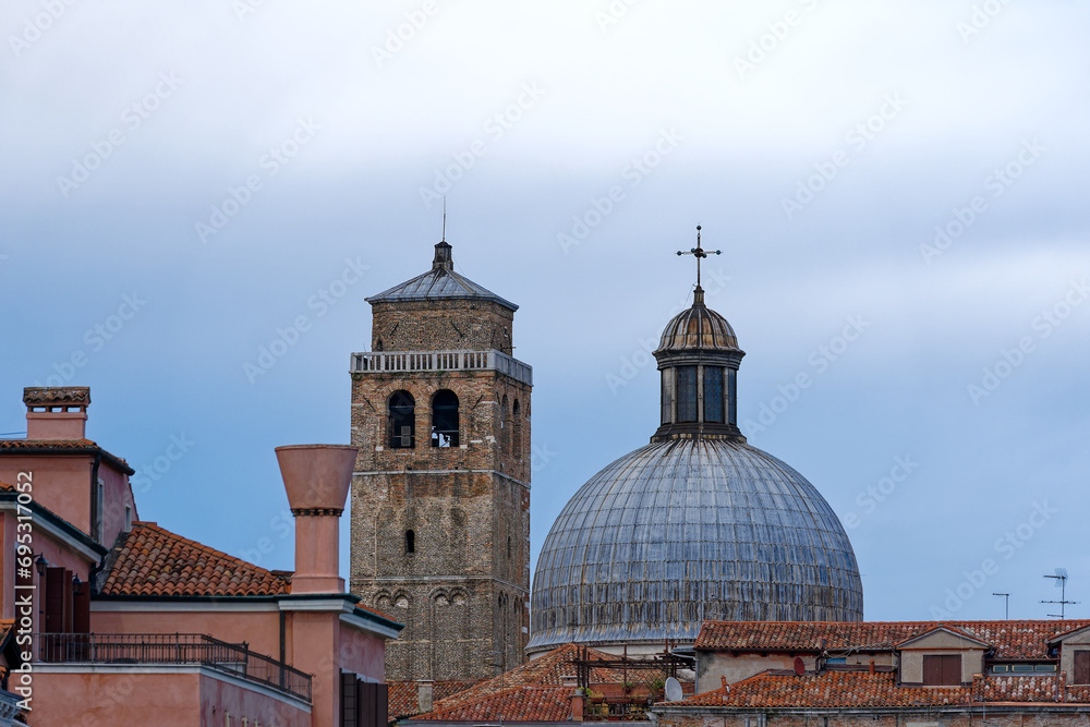 Scenic view of the old town of Venice with church tower of church Santi Geremia e Lucia and historic buildings on a cloudy summer day. Photo taken August 6th, 2023, Venice, Italy.