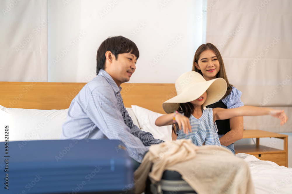 Portrait happy love asian family father and mother with little girl traveler packing stuff and outfit clothes in suitcases travel bag luggage for summer holiday weekend tourist vacation trip at home Portrait happy love asian family father and mother with little girl traveler packing stuff and outfit clothes in suitcases travel bag luggage for summer holiday weekend tourist vacation trip at home