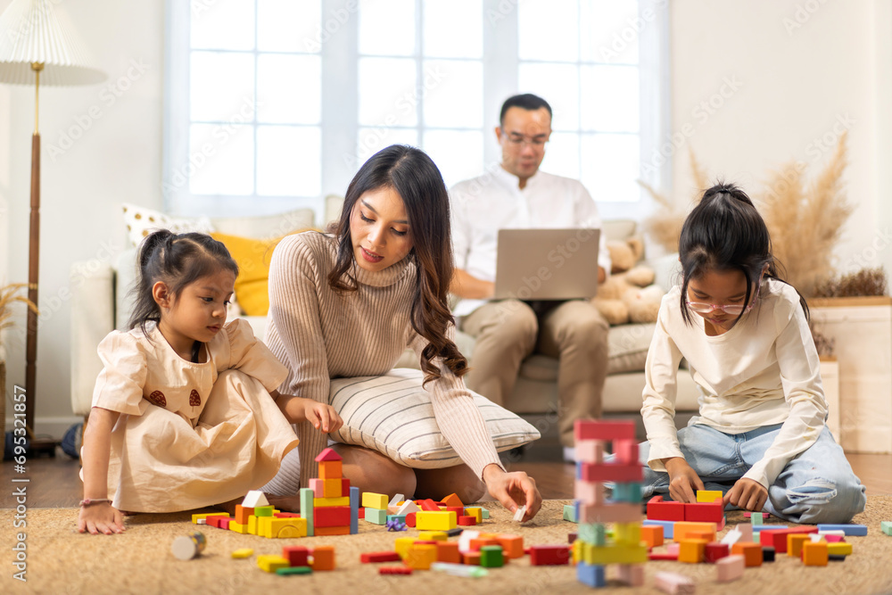 Portrait of enjoy happy love asian family father and mother with little asian girl smiling activity learn and skill brain training play with toy build wooden blocks board education game at home Portrait of enjoy happy love asian family father and mother with little asian girl smiling activity learn and skill brain training play with toy build wooden blocks board education game at home