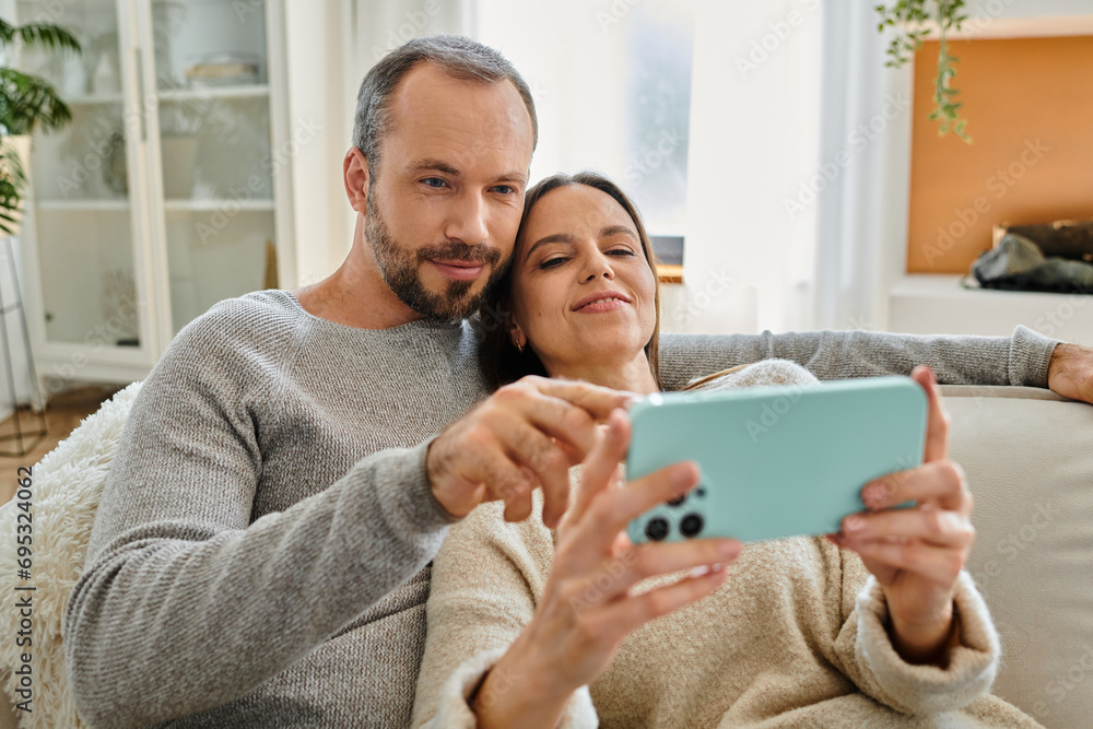 carefree child-free couple relaxing and browsing internet on mobile phone at home, quality time carefree child-free couple relaxing and browsing internet on mobile phone at home, quality time