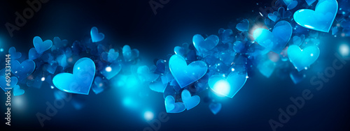 Blue bokeh heart sparkling on a dark background. Selective focus.