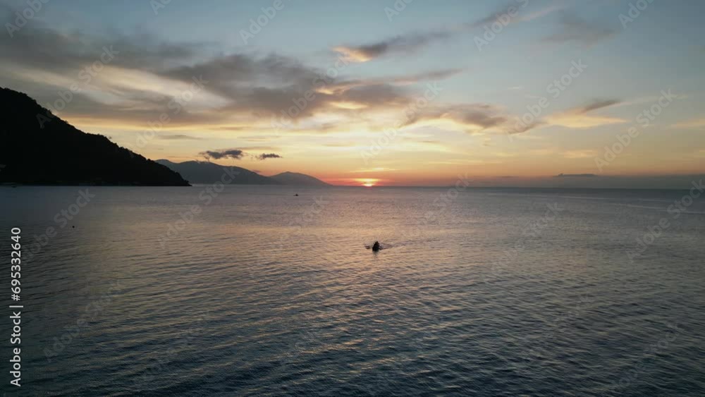 Tourist swims in ocean in tropical area at sunset in evening Tourist swims in ocean in tropical area at sunset in evening