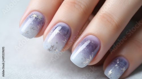 Manicured female hand showing short squoval winter wedding nail art ideas. Light pink-dark purple-white ombre with hand-drawn silver star shapes. photo