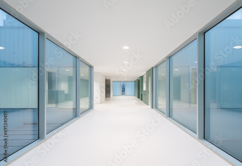 Hospital with empty white passage and glass walls photo