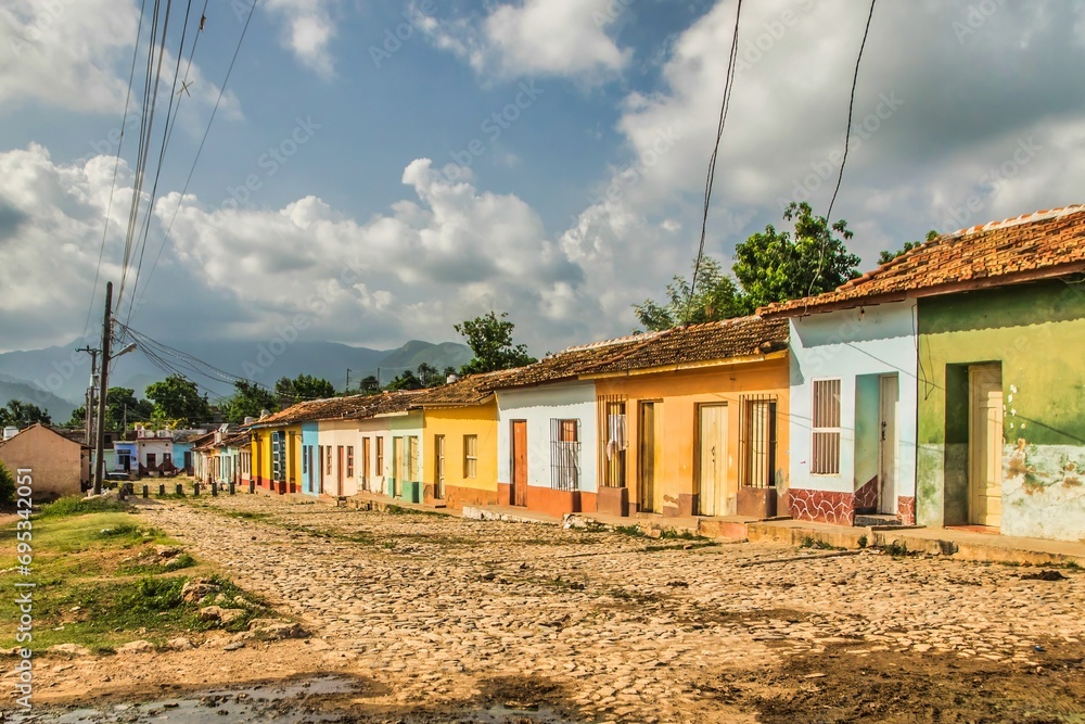Trinidad, Cuba - July 15 2018 :A former spanish colonial town still in the 18th century with cobble stone streets. Colorful houses along a street Trinidad, Cuba - July 15 2018 :A former spanish colonial town still in the 18th century with cobble stone streets. Colorful houses along a street