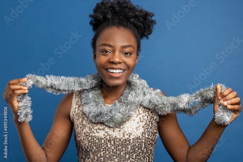 Photos Smiling woman in golden dress and with a necklet looking enjoyed