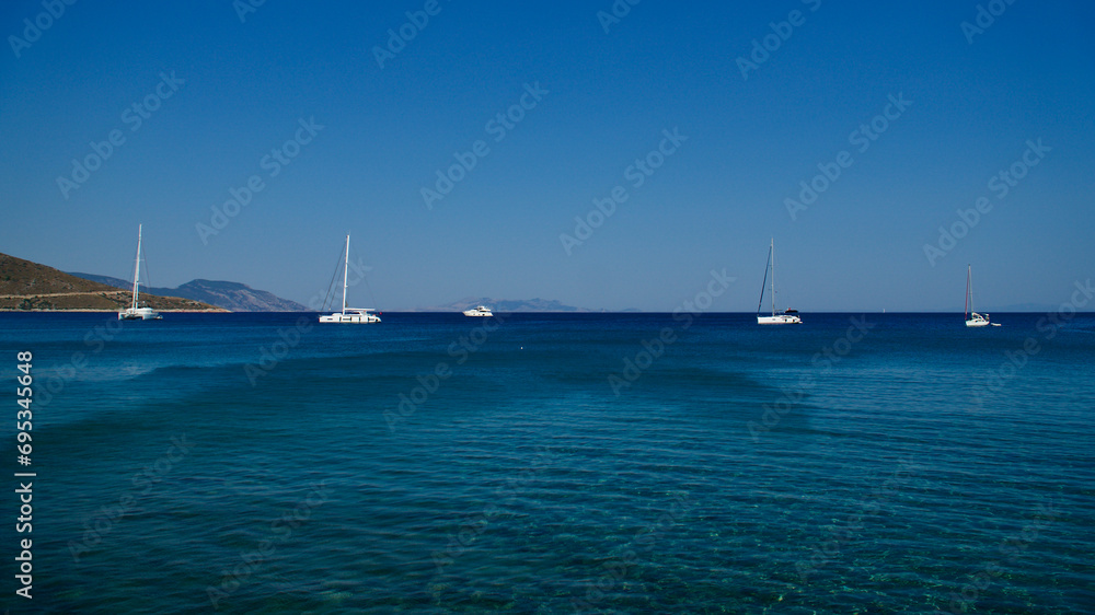 Luxury moto boats on blue sky and dark blue sea. Sailing and motor yachts. Tour boats called the bays.