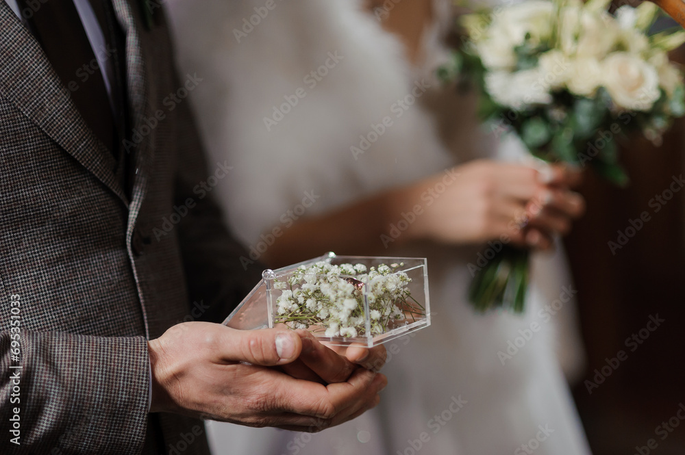 Box with gold wedding rings in the hands of the groom Box with gold wedding rings in the hands of the groom